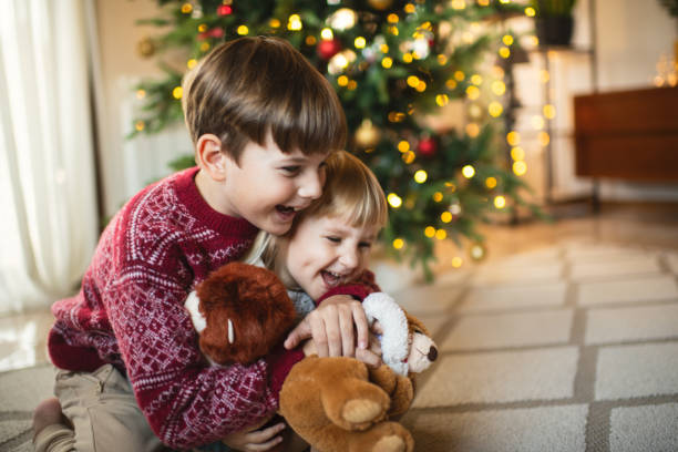 istock Happy children celebrating Christmas at home 2184302240