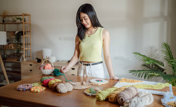 istock Punch needle. Asian Woman making handmade Hobby knitting in studio workshop. designer workplace Handmade craft project DIY embroidery concept. 2184304113