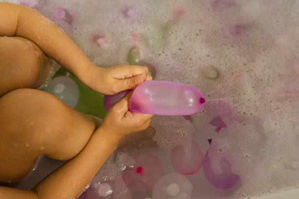 istock Child playing in bathtub with foam and bubbles. Kid bathing in bathtub. 2184305741