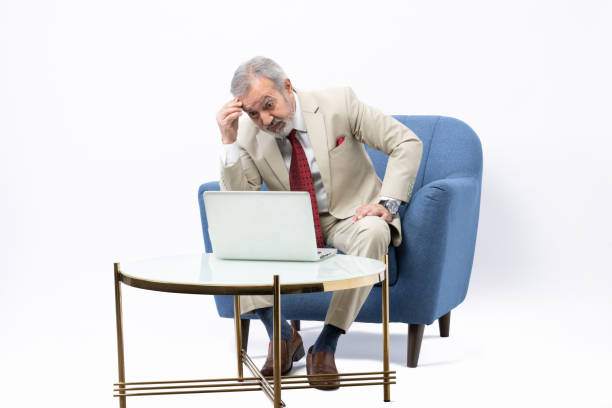 istock Senior man using laptop studio shoot stock photo 2184305842