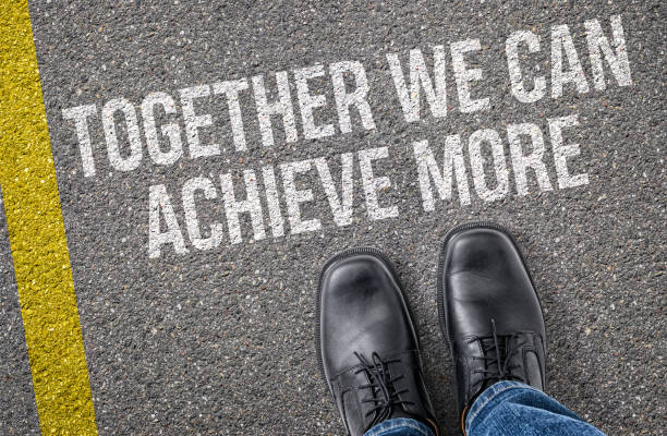 istock Text on the road - Together we can achieve more 2184308245