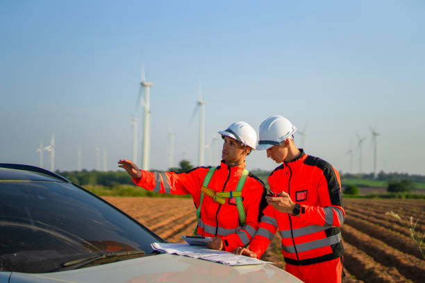 istock Engineers are working at windmills field for generate electricity. 2184308899