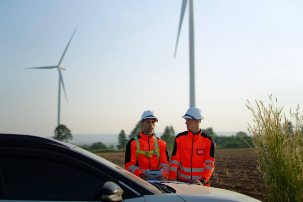 istock Engineers are working at windmills field for generate electricity. 2184308900