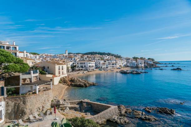 istock Stunning view of Calella de Palafrugell's pristine coastline featuring traditional whitewashed Mediterranean architecture, crystal-clear turquoise waters, and dramatic rocky outcrops along Costa Brava 2184310513