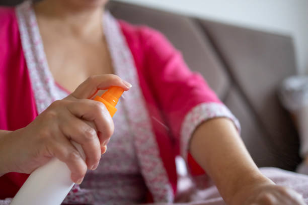 istock Woman applying hormone spray to her arm 2184310719