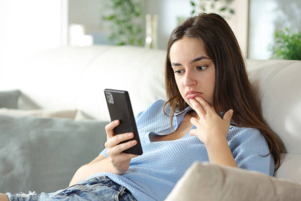 istock Uninterested woman checking phone content at home 2184311964