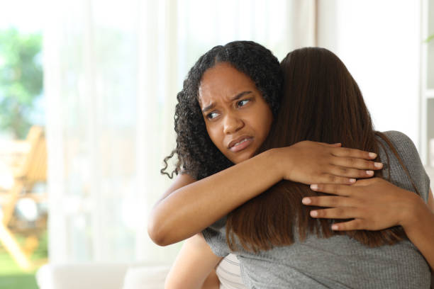 istock Disappointed false black woman hugging her friend 2184312260