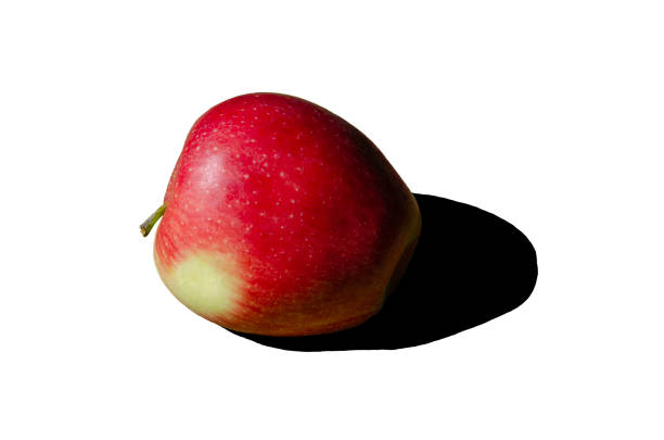 isolated on white background large one red apples with green spots placed on a white plate ideal fruits for healthy eating and snacking