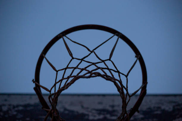 istock Old basketball hoop under blue twilight sky: ready for a game 2184315198