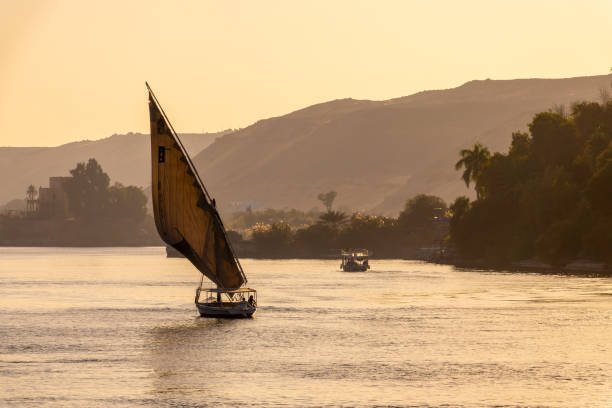 istock Felucca (traditinal egyptian sailing boat) on the Nile river at sunset  in Aswan, Egypt 2184316348