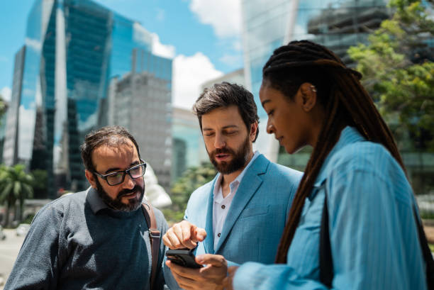 istock Coworkers using the mobile phone outdoors 2184316369