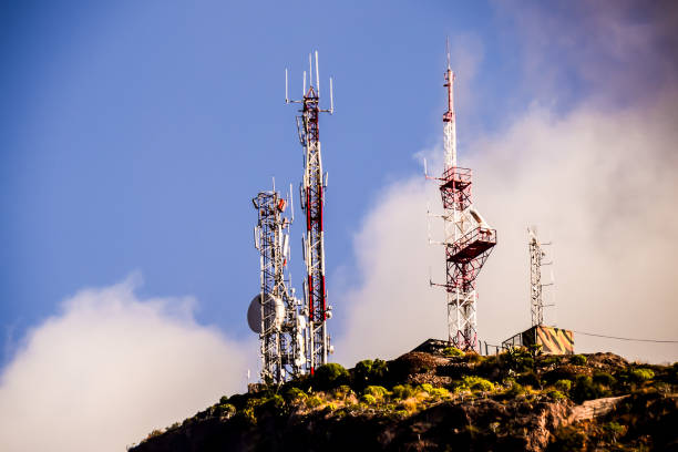 istock Three tall towers with antennas on top of a hill 2184316985