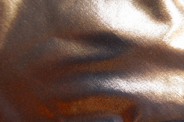 istock Texture of shiny bronze nylon and spandex lame fabric 2184317968
