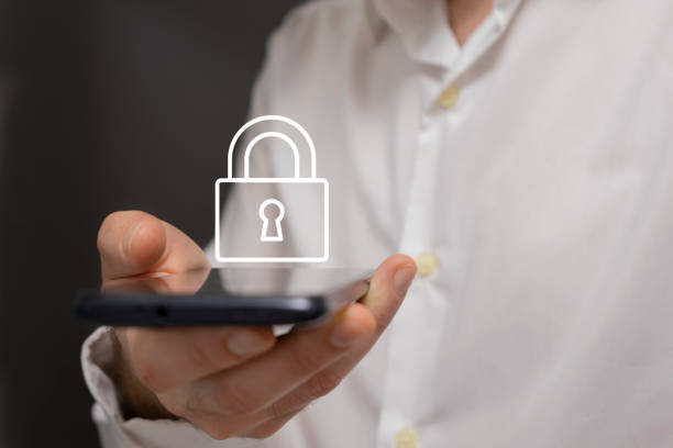istock Man holding a smartphone with a padlock icon on the screen. 2184318668