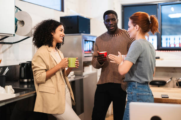 istock Multiracial coworkers enjoying coffee break in office kitchen 2184319265