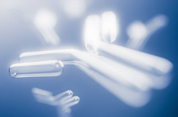 A collection of glowing antibodies floating in a serene blue background, representing medical research and scientific exploration with a futuristic feel. Perfect for healthcare and science themes.