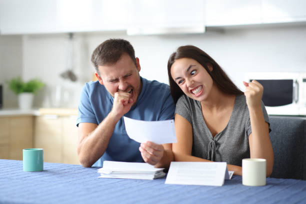 istock Angry couple checking bills at home 2184328163