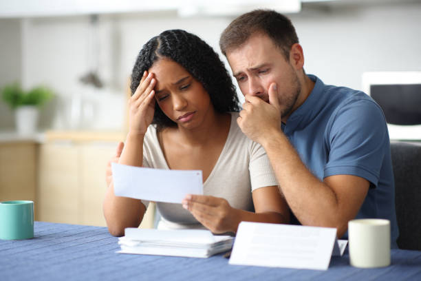 istock Worried interracial couple complaining reading invoice 2184328509
