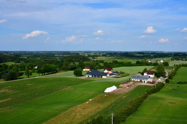 istock A view from the top of a tall hill or mountain showing various fields, meadows, and pasturelands surrounded with forests, moors, small villages and farmlands spotted on a sunny summer day in Poland 2184330296