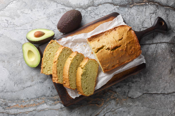 istock Freshly baked diet avocado bread close-up on wooden board. Horizontal top view 2184332723