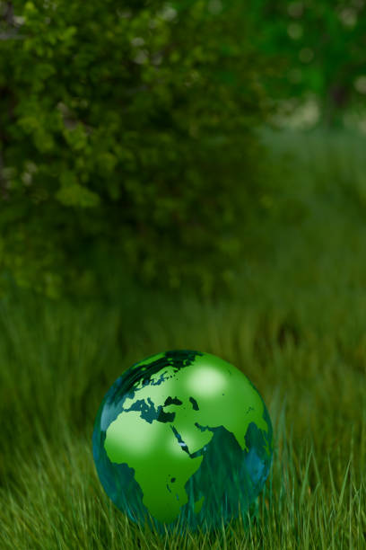 A green globe rests on grass, symbolizing Earth Day and environmental awareness. 3d rendering
