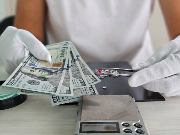 istock Buying diamonds jeweler keeps cash dollar 2184336443