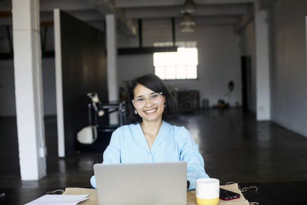 istock A young business woman smiling at the camera happy at work 2184337122