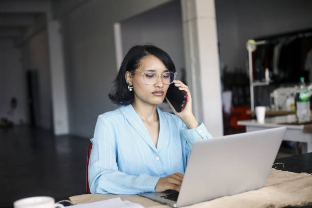 istock A young woman is focused at work taking a phone call 2184337527