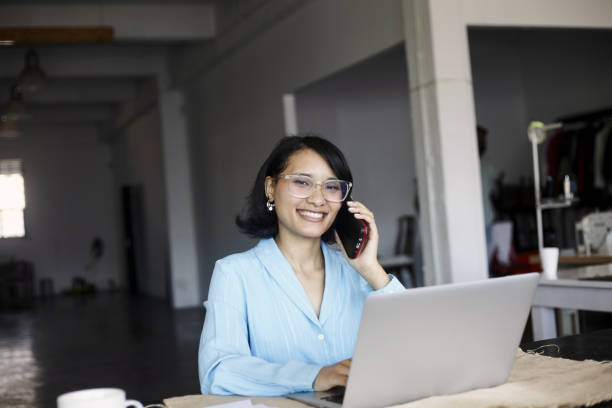 istock A young woman smiling happy on call at work 2184337531