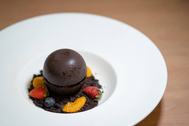 Chocolate ball dessert served with fresh fruits.