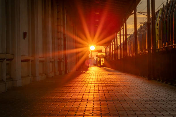 Sunset with railway track and platform semaphore silhouette and trains in Chocen CZ 11 08 2024