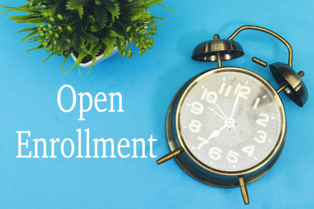istock open enrollment concept with alarm clock, time to registration 2184344059