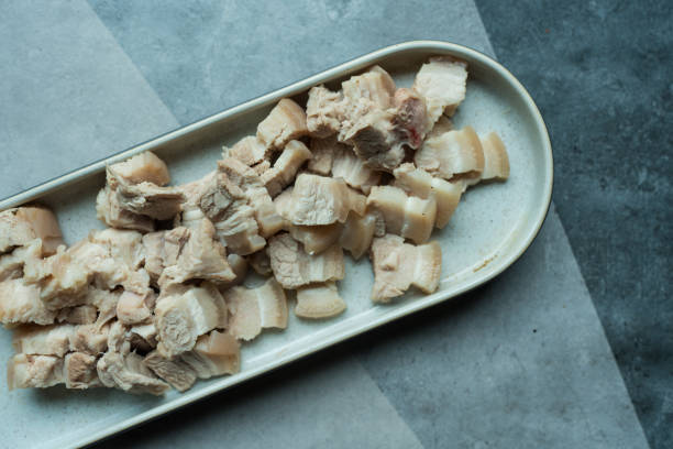 istock Slices of boiled pork belly bite sized pieces in long tray 2184344510