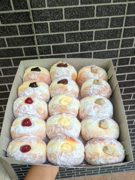 istock Bomboloni, soft Italian doughnuts filled with creamy custard or jam, dusted with powdered sugar. Fluffy and indulgent, they’re a perfect sweet treat, enjoyed fresh and warm with every bite. 2184345117