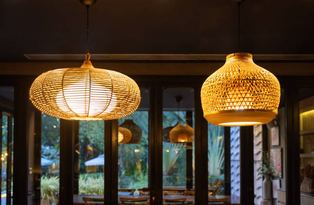 istock Two handmade lamps with a woven design hanging from the ceiling. 2184345722