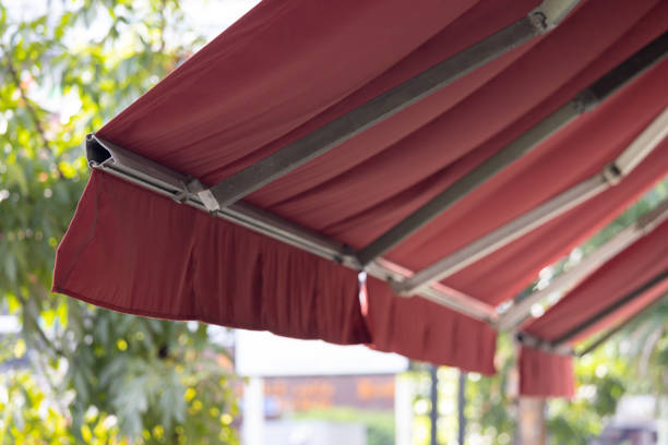 istock A red awning with a white trim is hanging over a sidewalk 2184345723