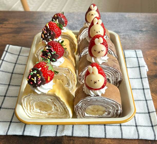 Tasty roll cake, sponge roll, Swiss roll stuffed with cream cheese ,decorated with fresh raspberries.