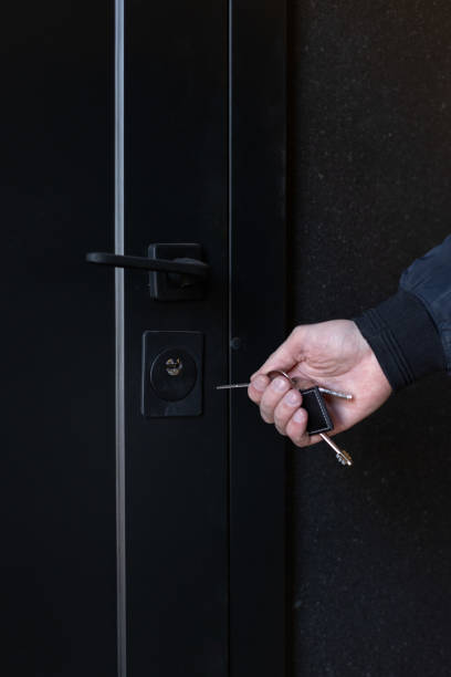 istock Man with key opening front door, closeup 2184347029