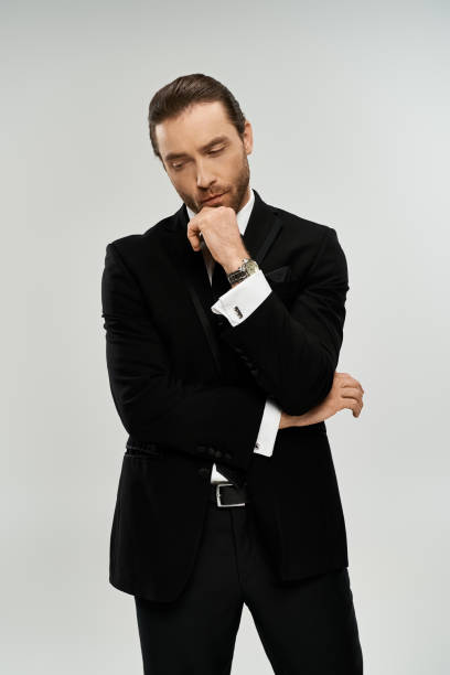 istock A young man in a stylish suit deep in thought against a neutral backdrop during a photoshoot 2184348444