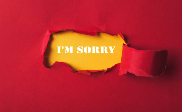 istock Red background with a hole in it and the words I'm sorry written in white 2184349540