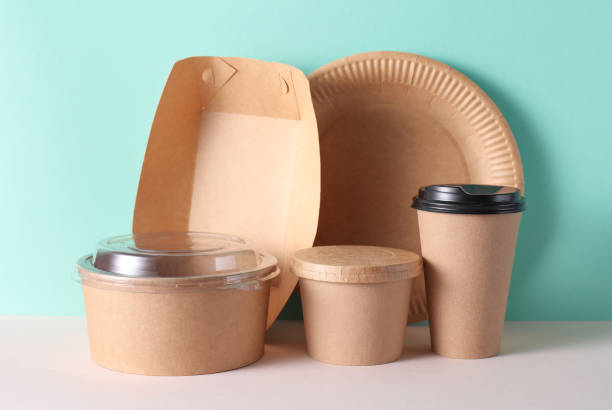 istock Cardboard takeaway food containers on mint green background 2184351042