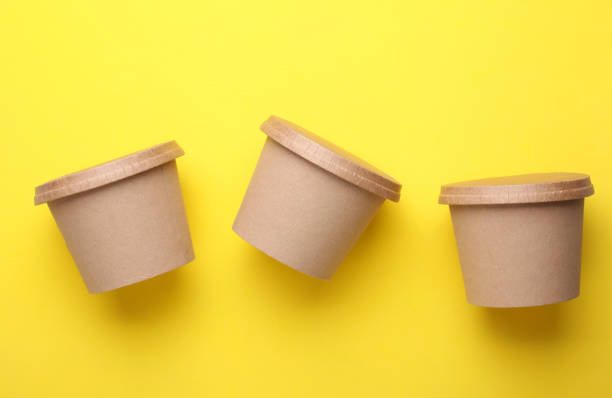 istock Eco cardboard round food boxes on yellow background. Top view 2184351164