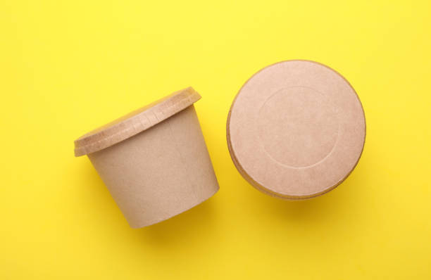 istock Eco cardboard round food boxes on yellow background. Top view 2184351172