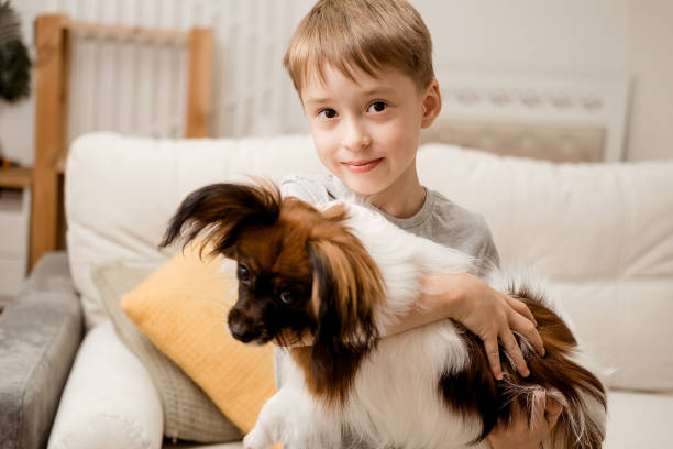 istock A happy Caucasian boy hugs his dog. 2184351876