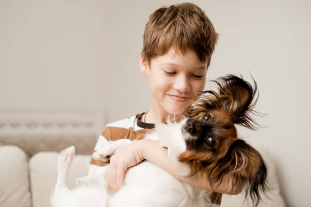 istock A happy Caucasian boy hugs his dog. 2184351895