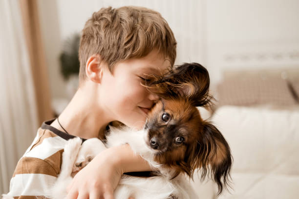 istock A happy Caucasian boy hugs his dog. 2184351903