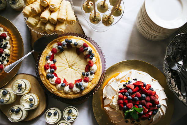 istock Wedding sweet table with cakes. Elegant sweets corner for catering, featuring chocolate treats with fruit toppings. 2184355907