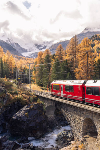 istock Swiss red train in Autumn mountain scenery 2184356551