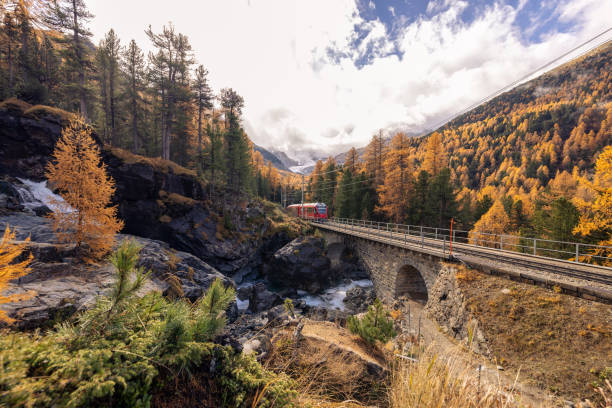 istock Red Train Crossing Scenic Autumn Bridge 2184357332