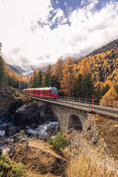 istock Red Train Crossing Scenic Autumn Bridge 2184357341